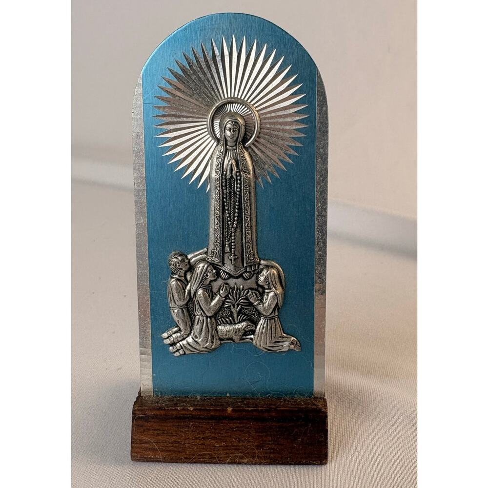 VTG LADY OF LOURDES SOUVENIR FEATURING A SILVER TONE METAL ON BLUE BLACKGROUND
